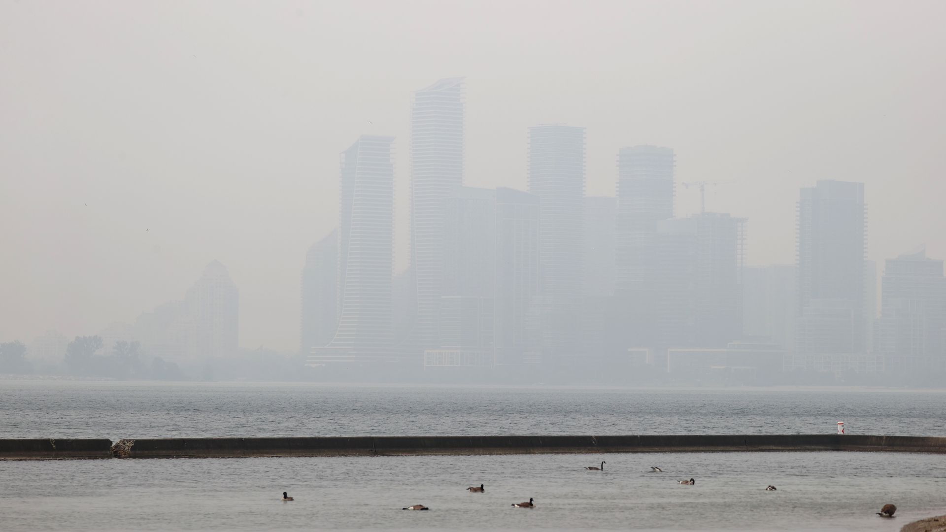 Buildings as smoke from northeastern Ontario and central western Quebec wildfires creates haze in Toronto, Ontario on June 28, 2023. Environment Canada issued air quality warnings for the Northwest Territories and huge areas of the heavily-populated provinces of Ontario and Quebec. 