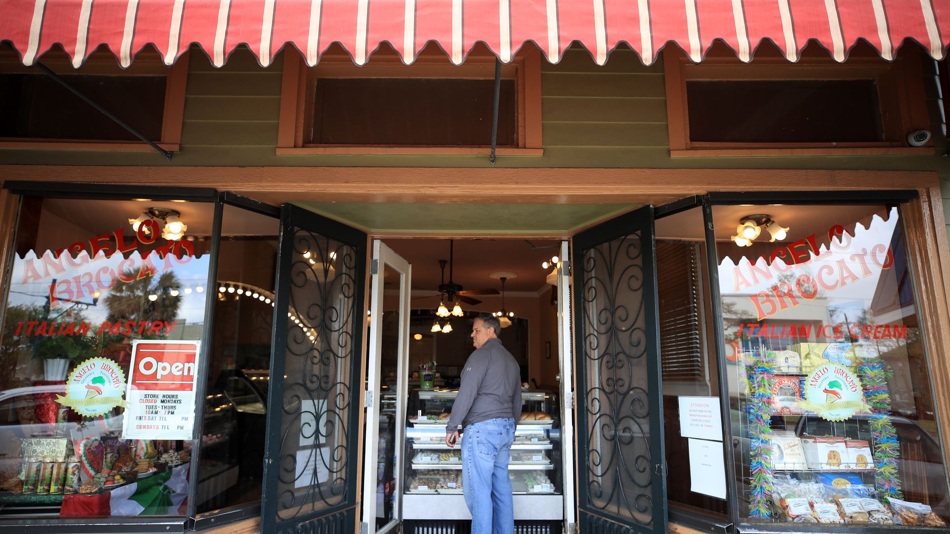 man stands in the doorway of a bakery in new orleans