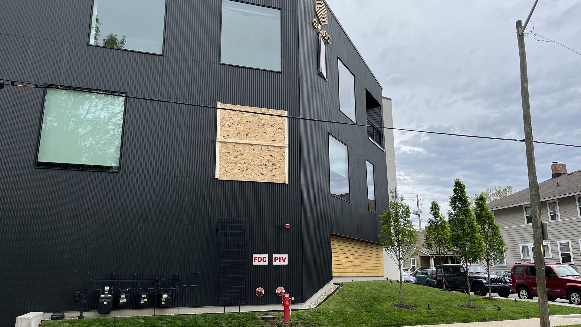 A window boarded up on the Gbloc apartment building. Photo: Arika Herron/Axios