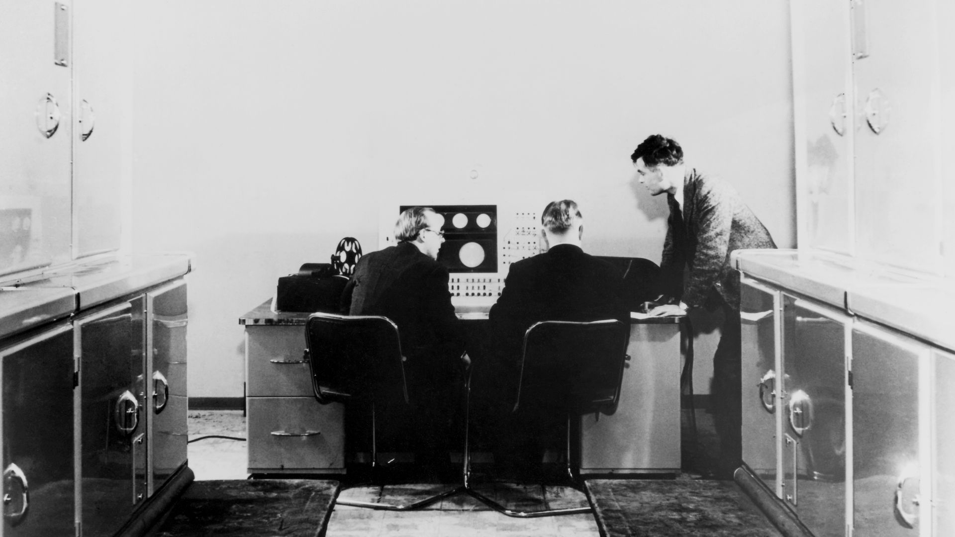 Alan Turing and colleagues working on the Ferranti Mark I Computer, 1951.