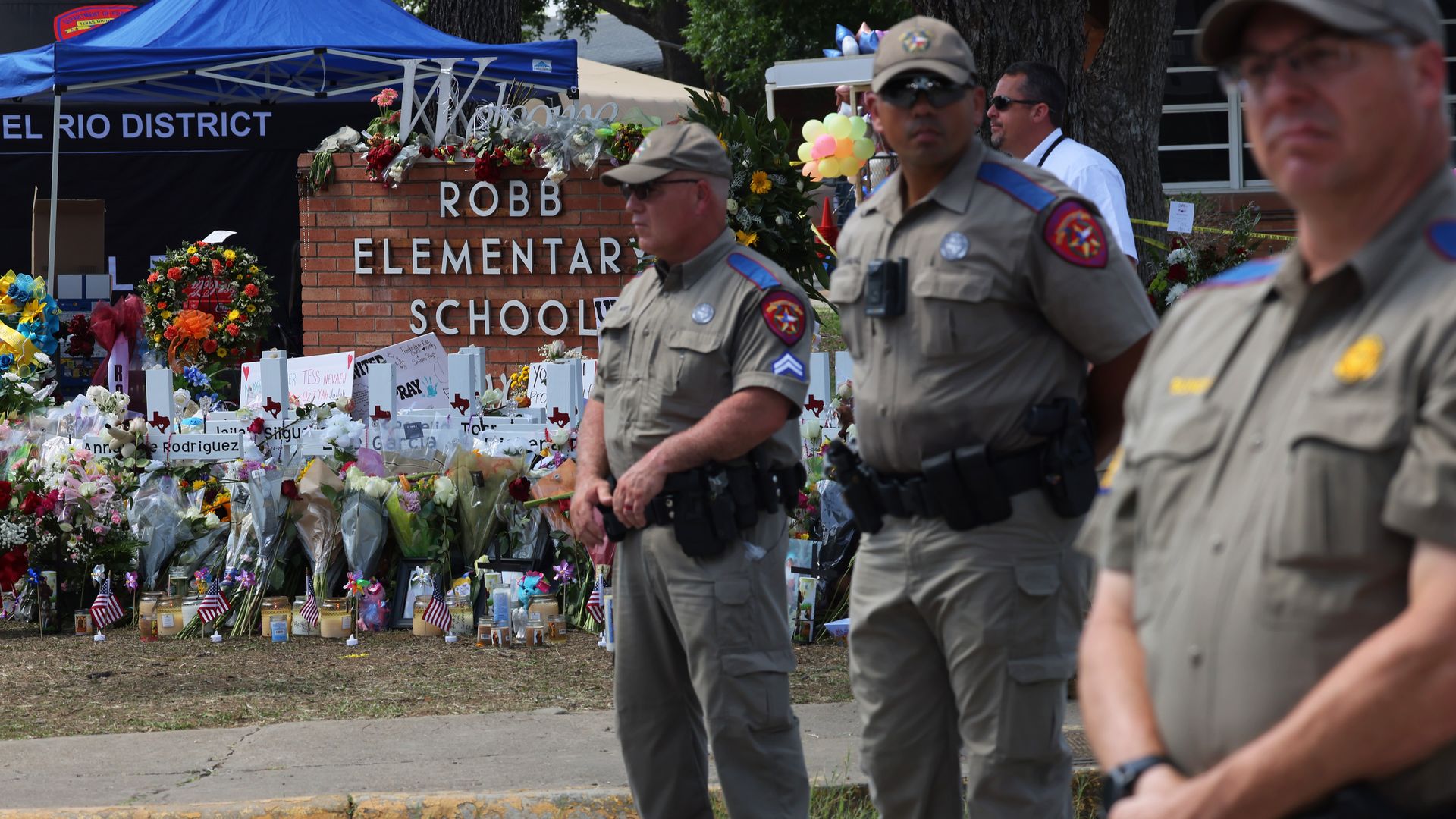 Texas Highway Patrol officers in front of a memorial for the victims of the mass shooting at Robb Elementary School in May 2022 in Uvalde, Texas.