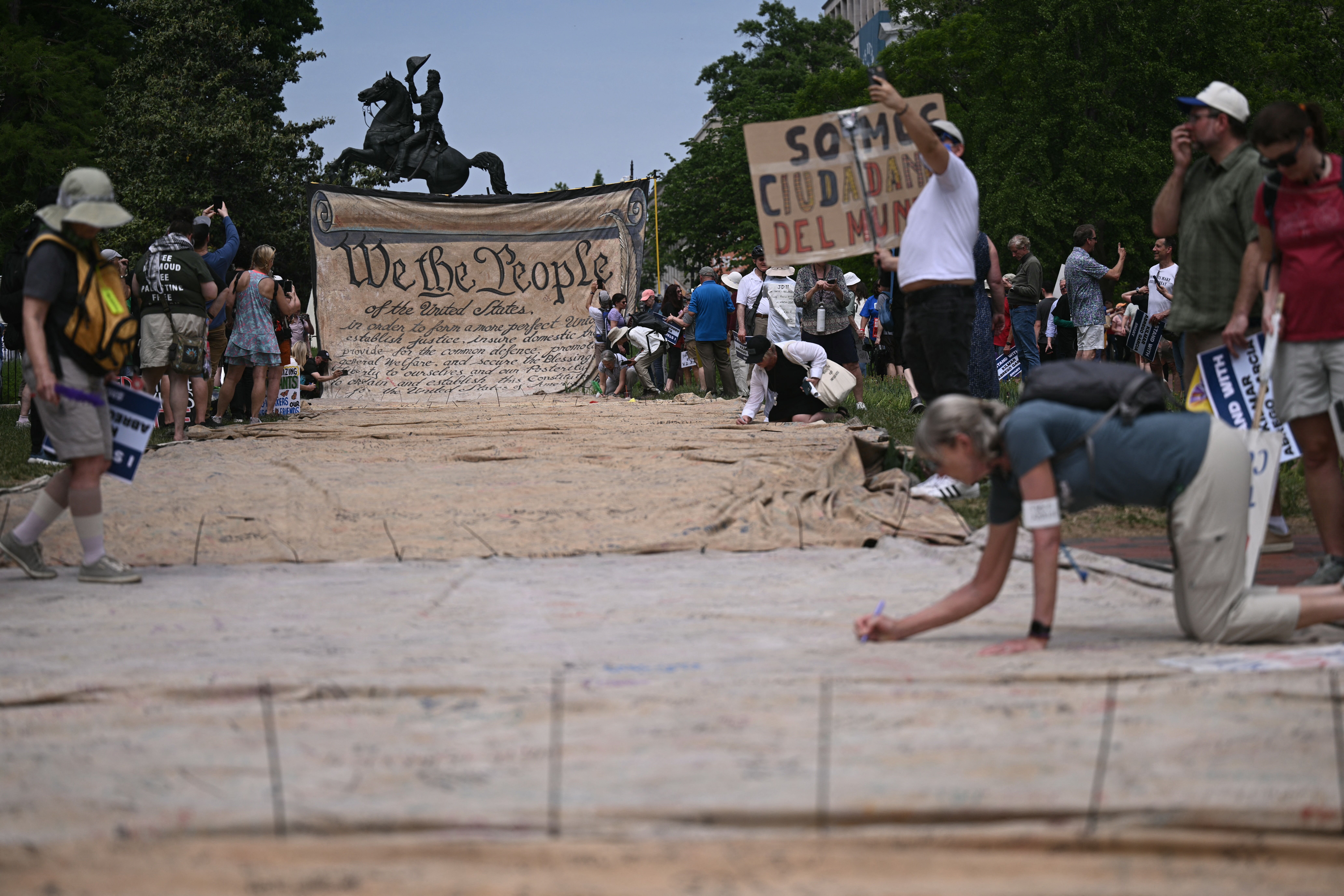 People sign a large replica of the Declaration of Independence