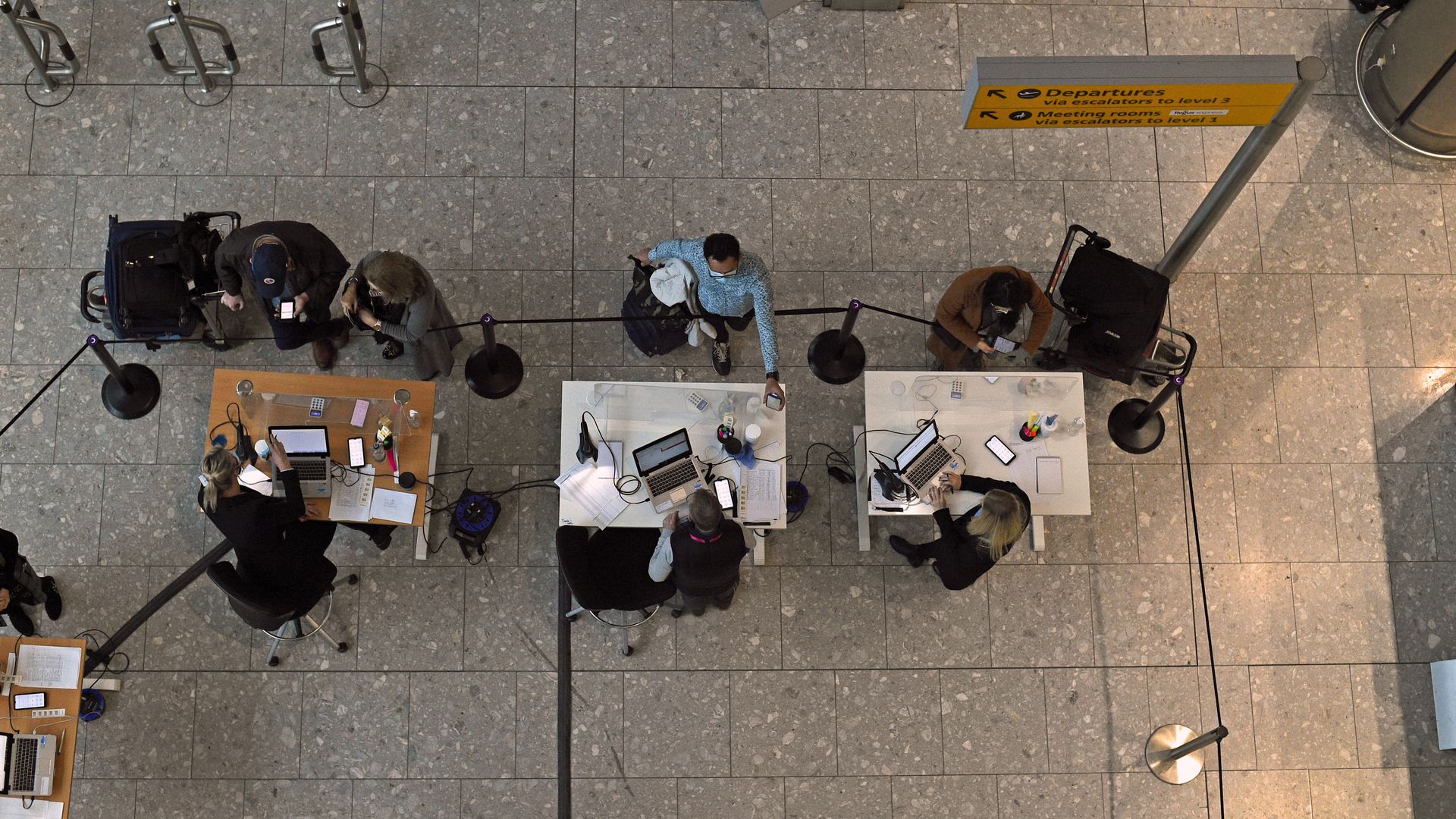 Picture taken from above of three tables and people talking around the tables