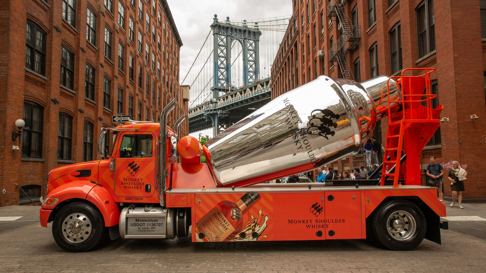 A cement mixer, with the main, rotating cylinder in the shape and color of a bartender's mixing tumbler. 