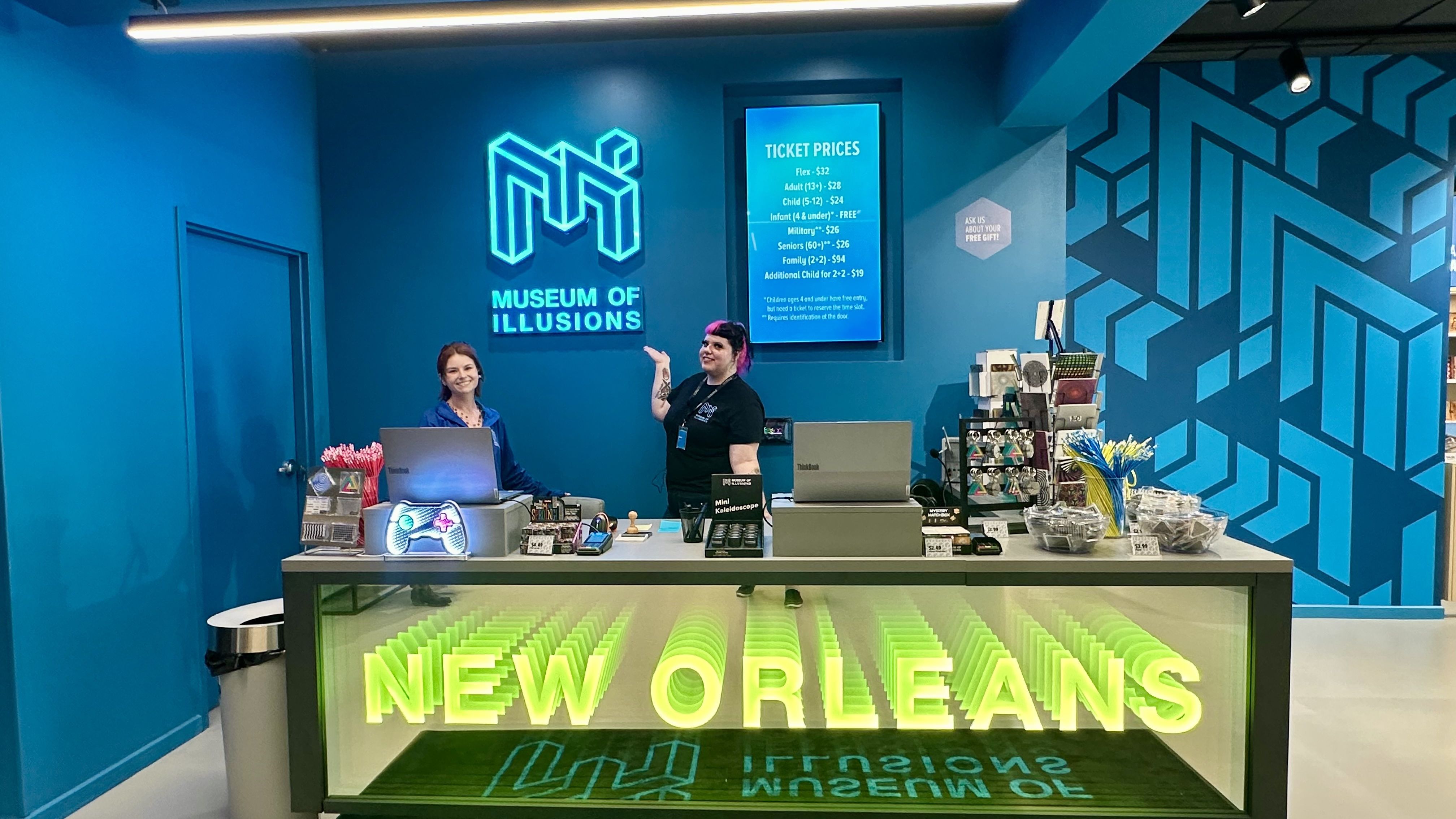 Photo shows two women behind a ticket counter