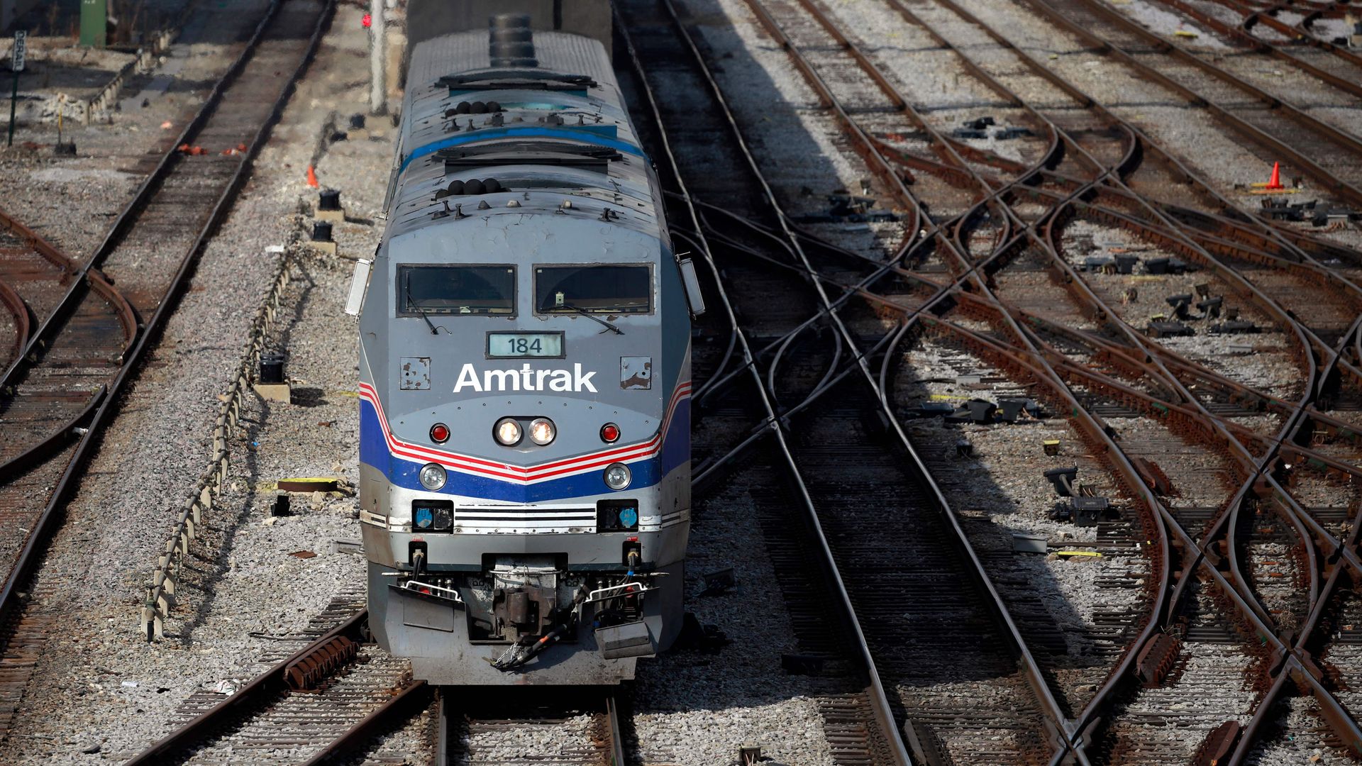 An Amtrak train departing a station. An Amtrak train departing a station.