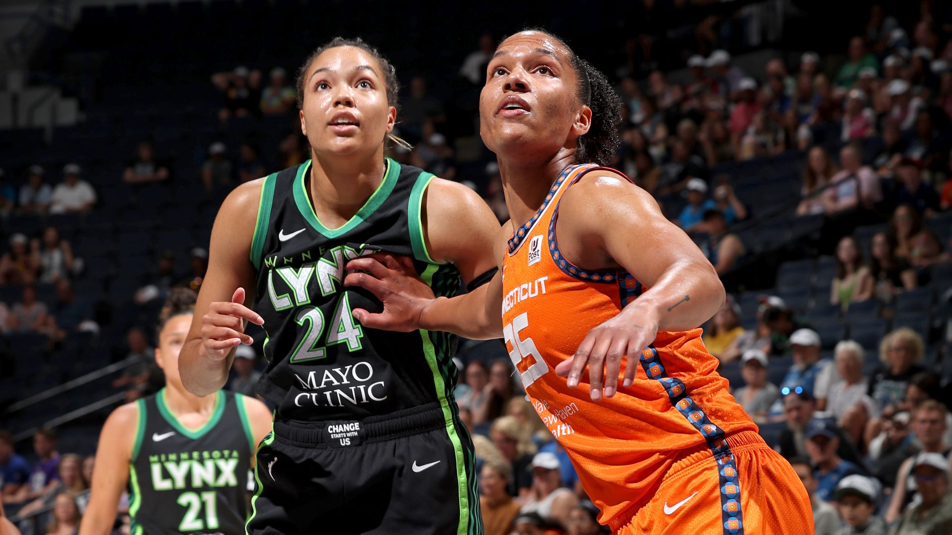 Napheesa Collier and Alyssa Thomas battle for a rebound
