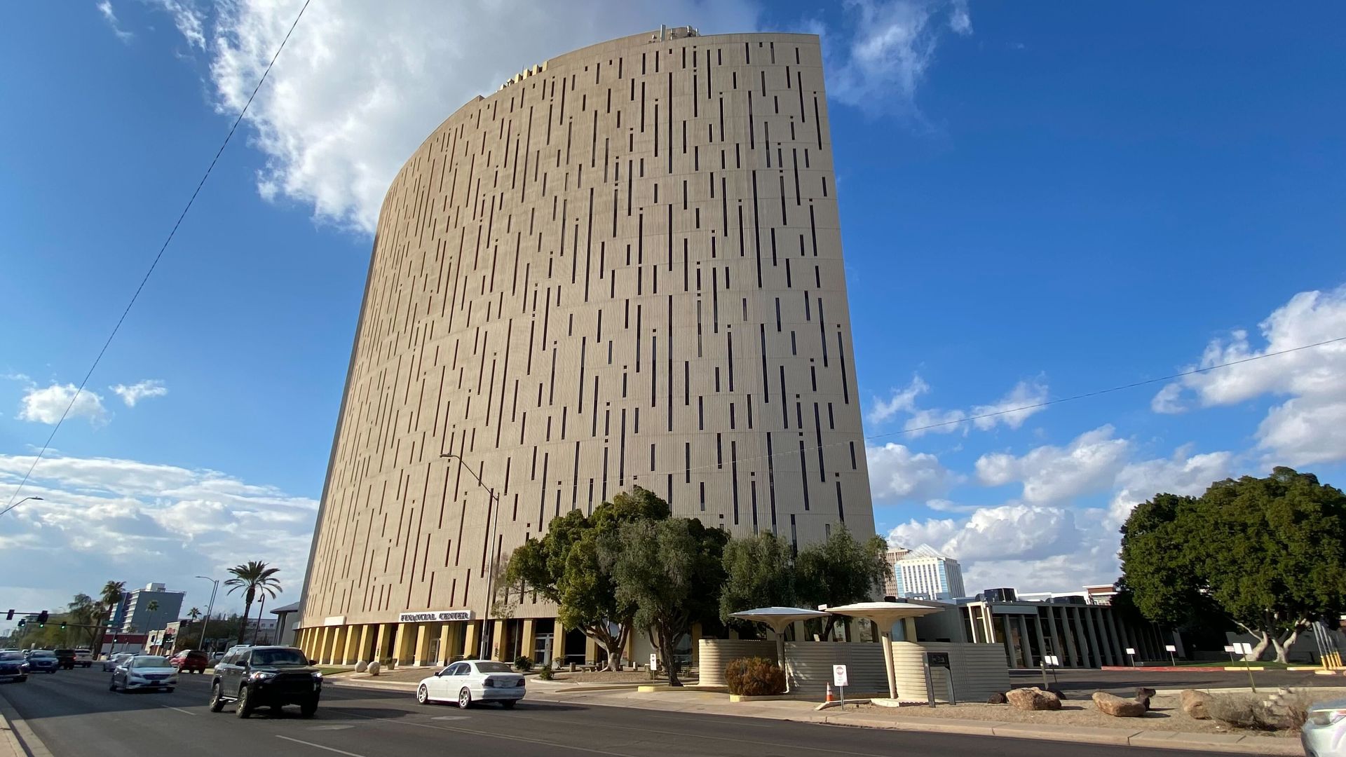 A tall building that has punchcard-like slots on it. 