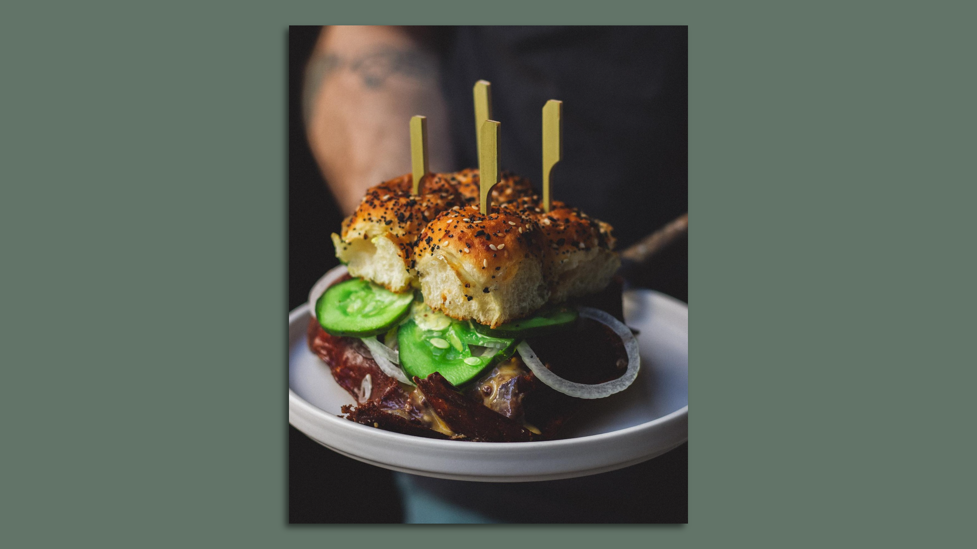 Four-in-one break-apart slider cheeseburgers on a plate. 
