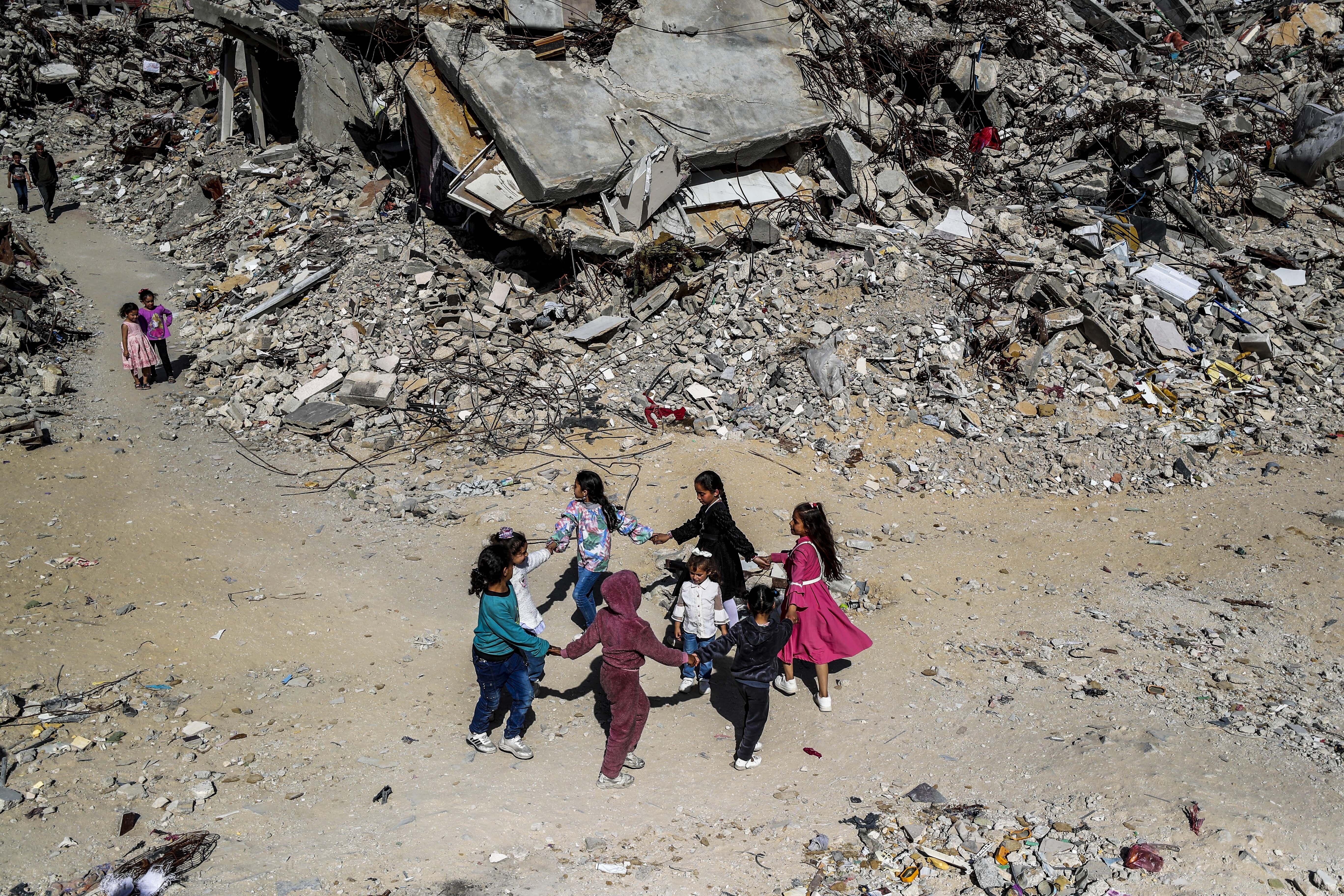 GAZA CITY, GAZA - MARCH 31: Palestinian children living in Jabalia refugee camp play games among the rubble of buildings destroyed by Israeli attacks in Gaza City, Gaza on March 31, 2025. Palestinians in Gaza are trying to keep the atmosphere of the Eid al-Fitr holiday alive despite the ongoing Isra