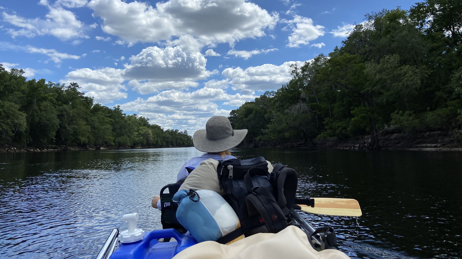 person canoeing on river