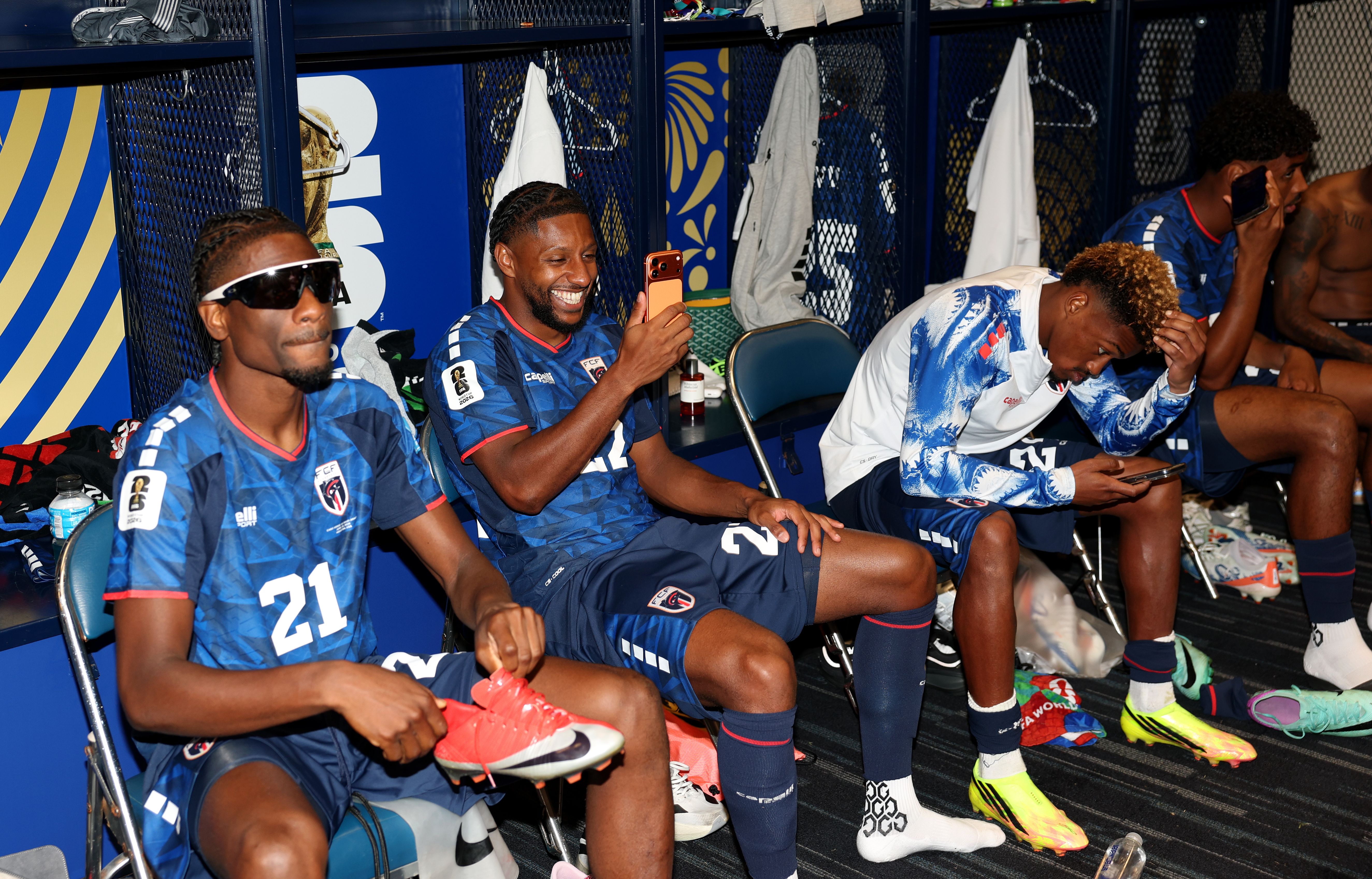 Cape Verdean soccer players celebrate in the locker room 