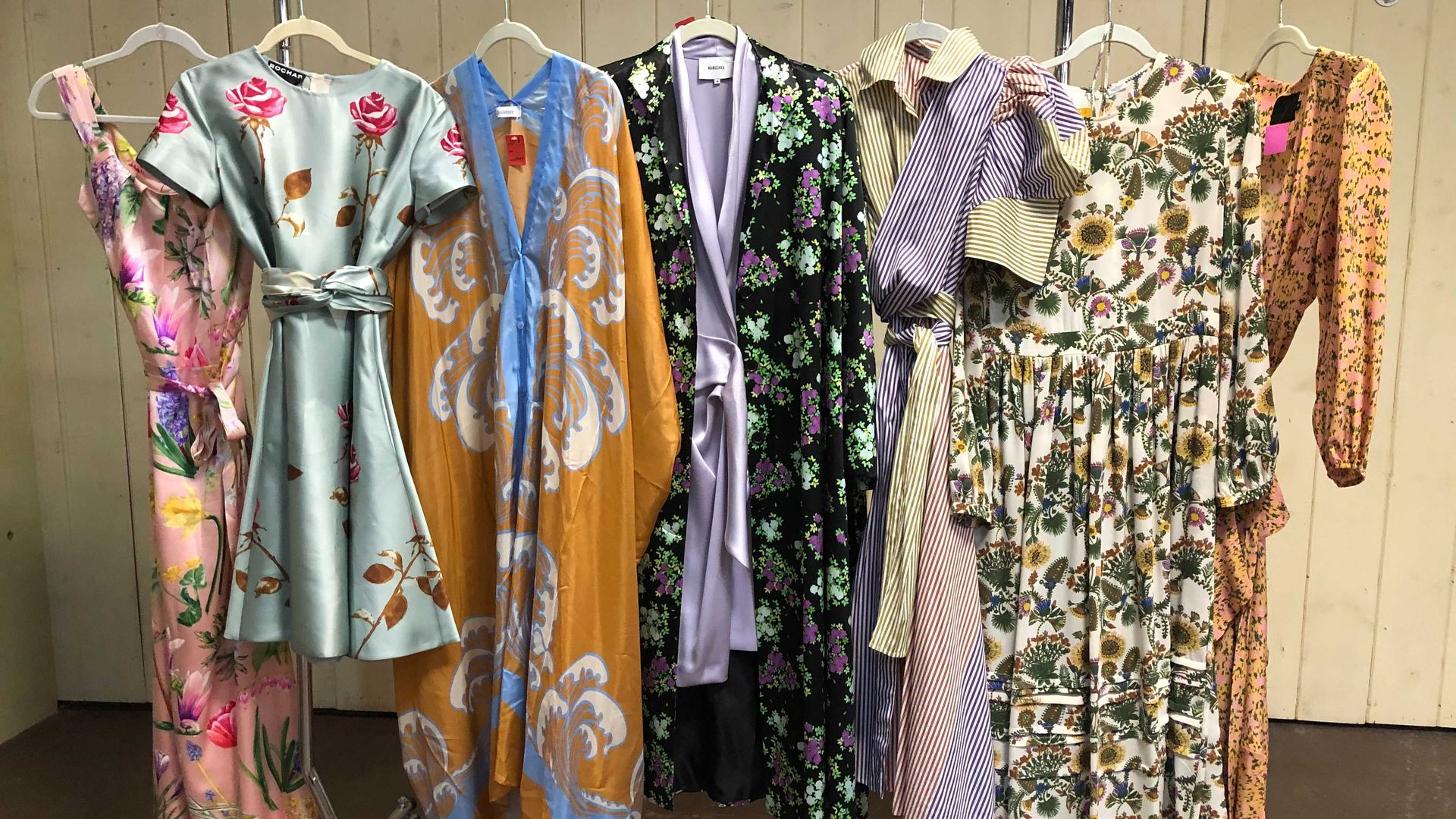 designer dresses of all different colors on a rack