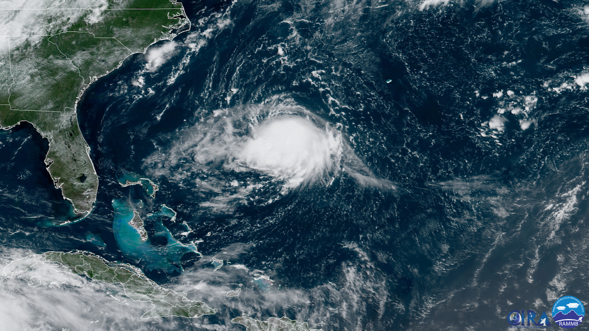 Satellite image showing a group of white clouds that is organized into a tropical storm.