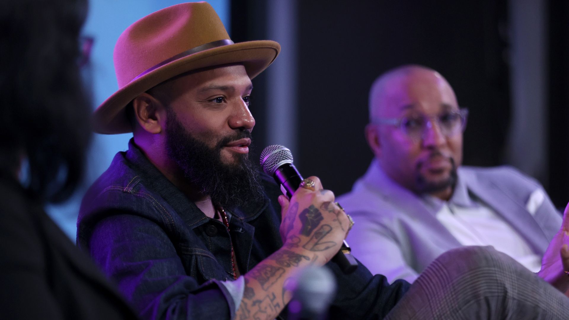 Justin Sutherland holding a microphone.