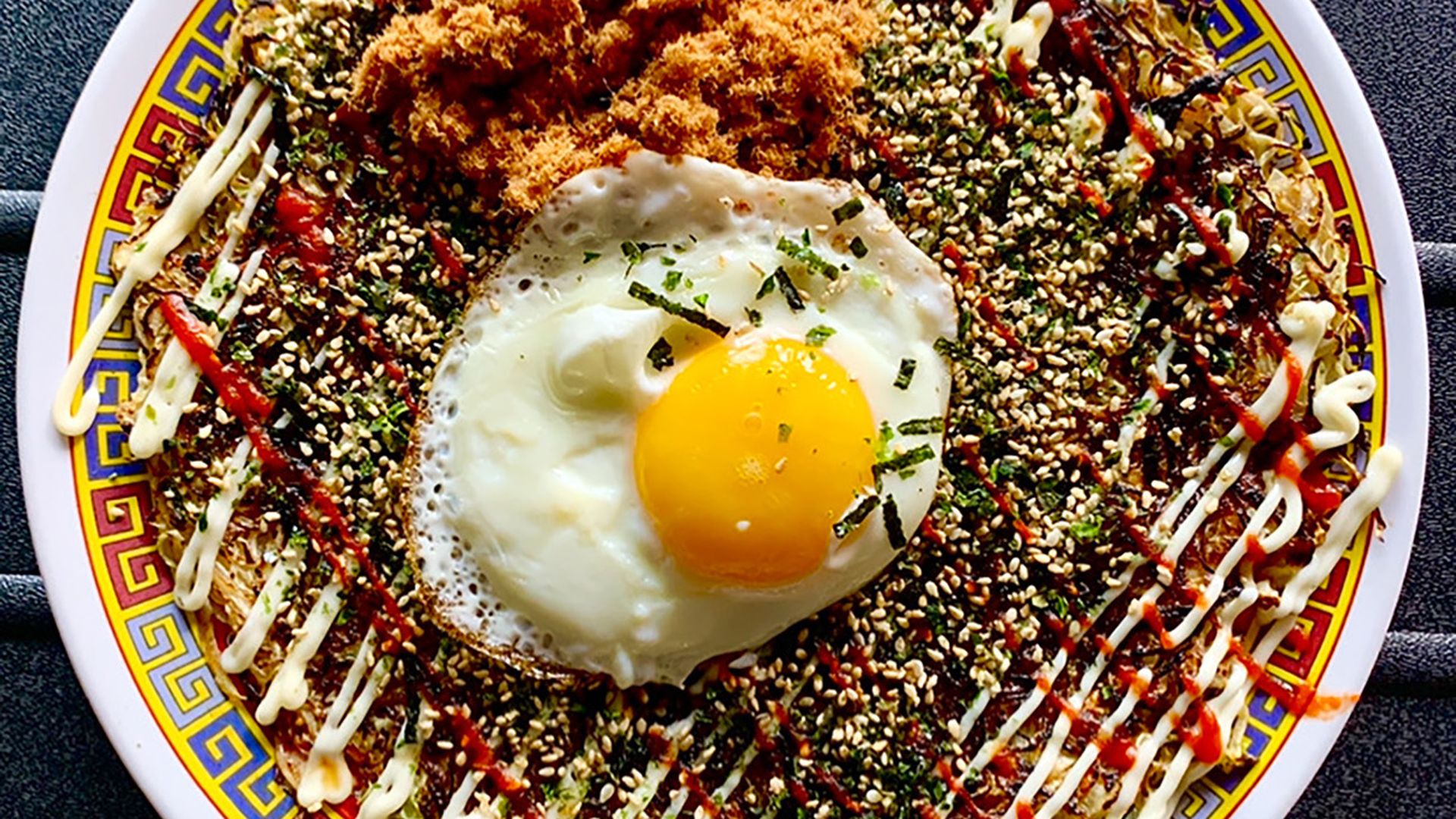 A dish from Xiao Bay, with an egg sunny side up on top of other food