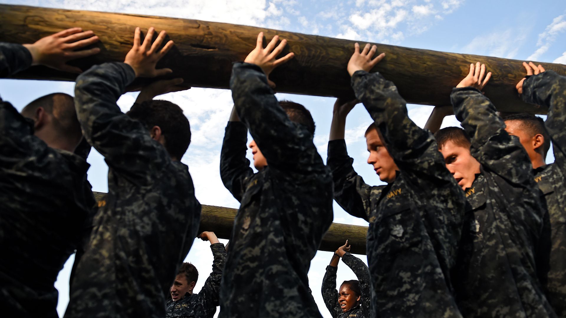 Members of the United States Naval Academy freshman class lift logs during the annual Sea Trials training exercise at the U.S. Naval Academy on May 13, 2014 in Annapolis, Maryland. 