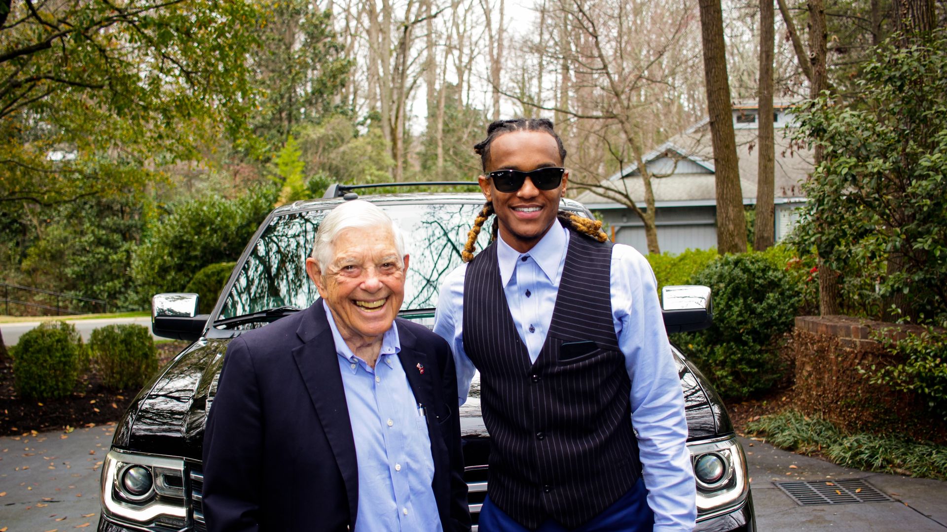 Hugh McColl in a blue shirt and sport coat next to Myles McGregor in a blue shirt and vest