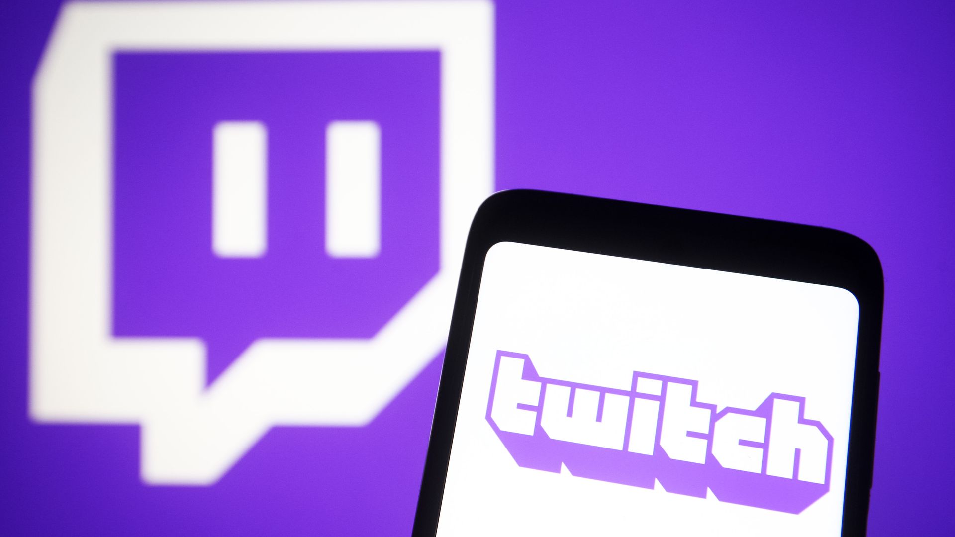 Twitch logo seen displayed on a smartphone and a pc screen