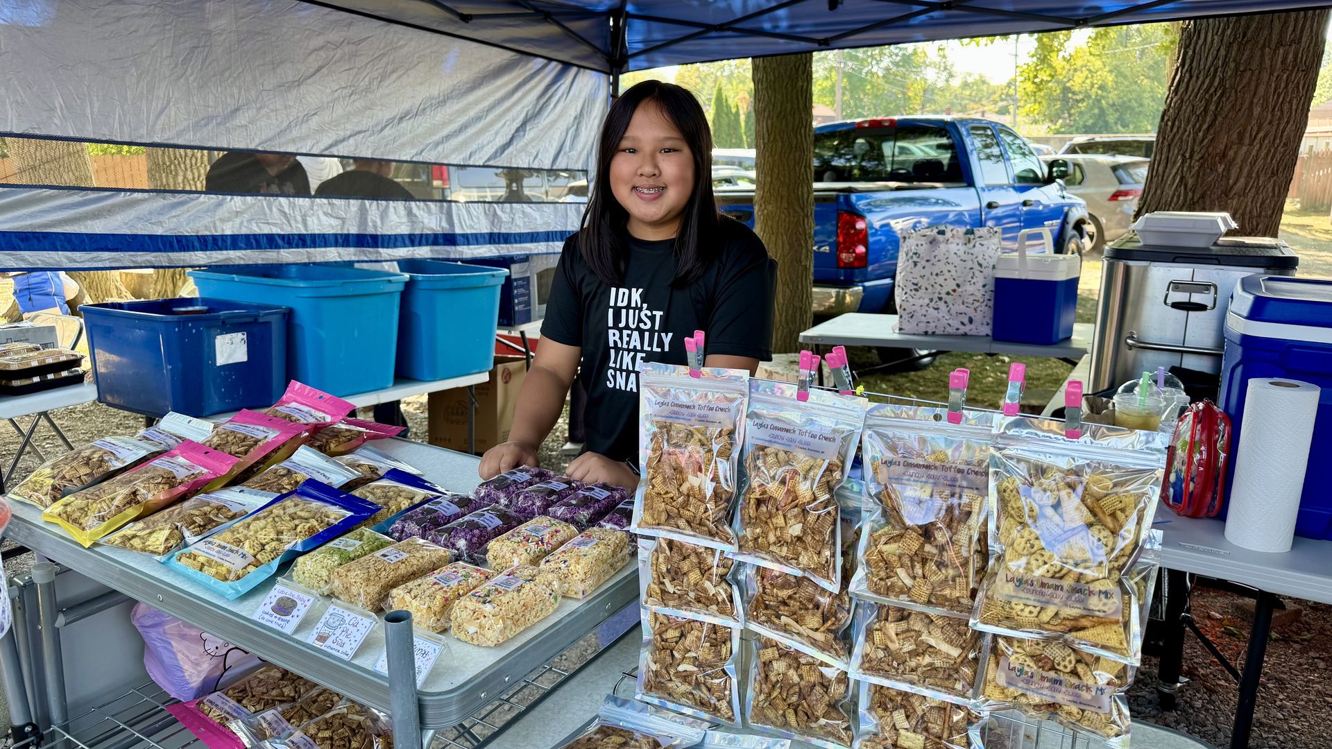 The young entrepreneur pictured standing behind her offerings - rice krispies and snack mixes.