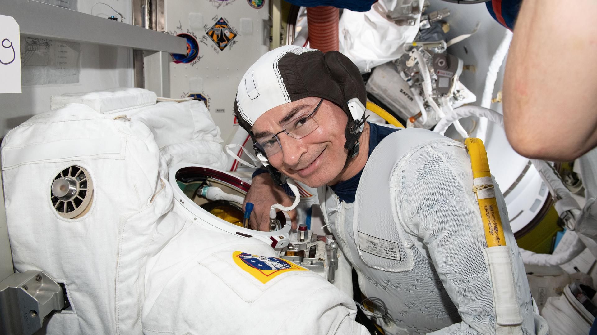 NASA astronaut Mark Vande Hei inspecting a flight suit aboard the International Space Station in August 2021.