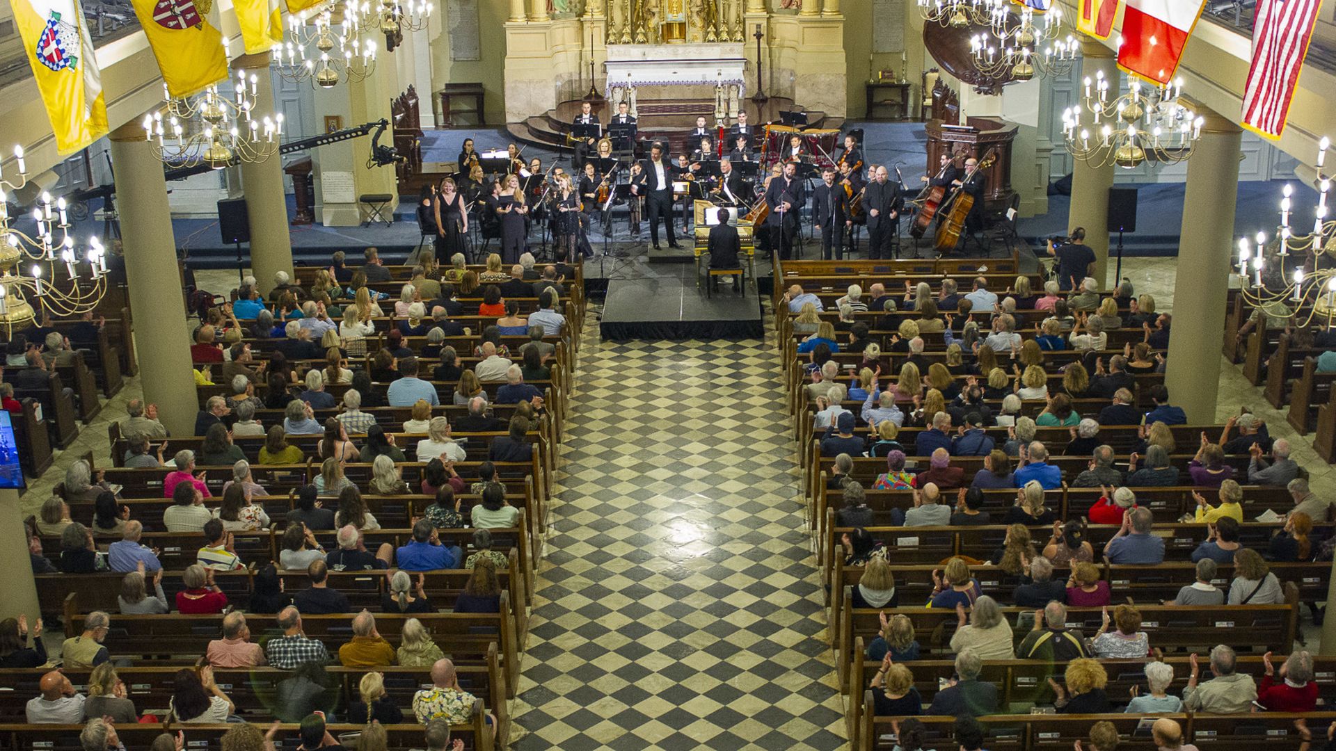 A birds-eye view of the St. Louis Cathedral as a classical music performance occurs.