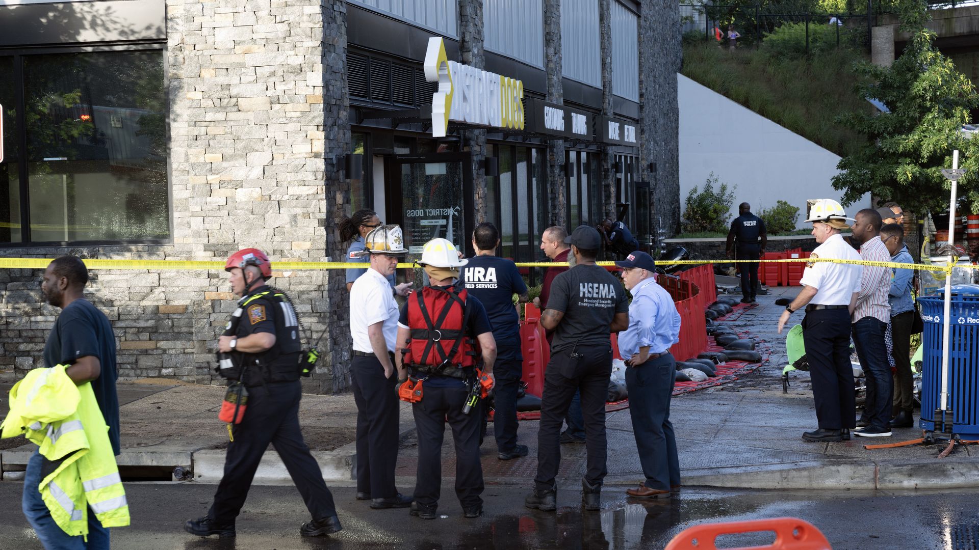 A photo showing authorities standing outside a dog boarding facility with caution tape surrounding it.