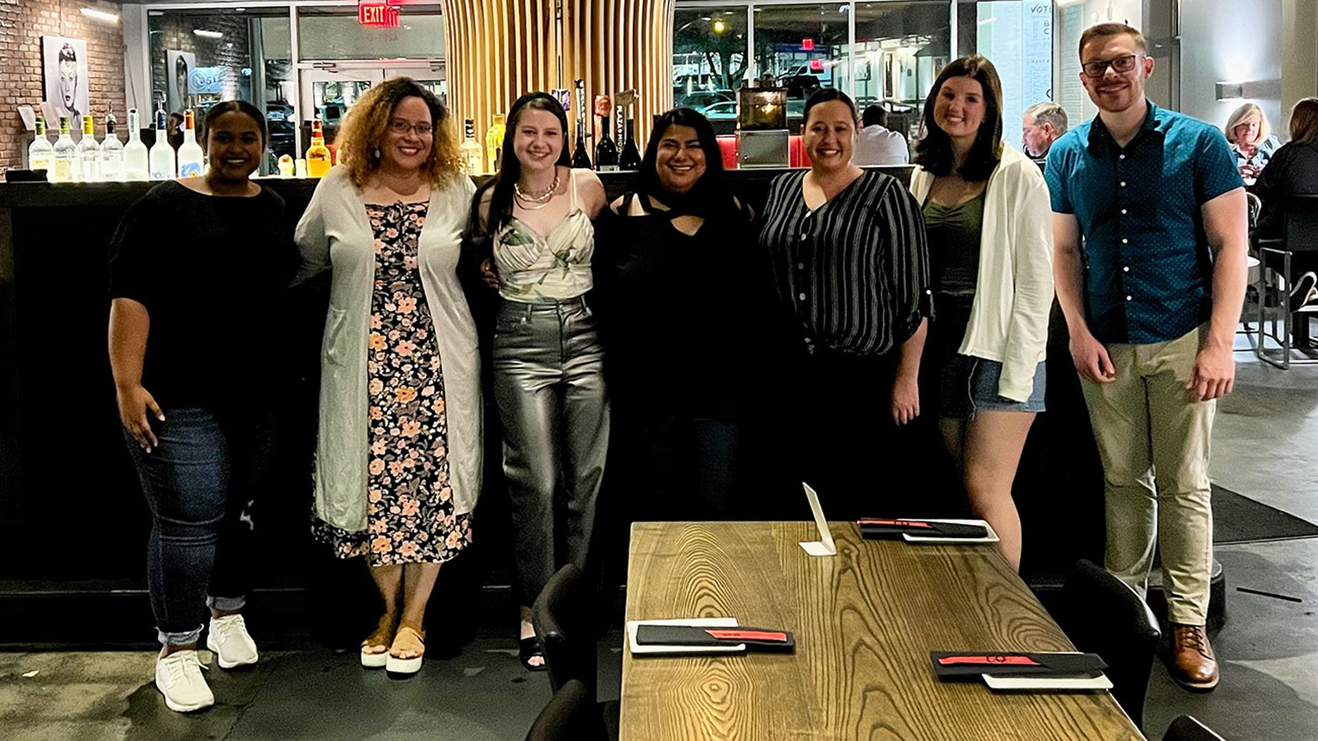 Friends pose in a restaurant