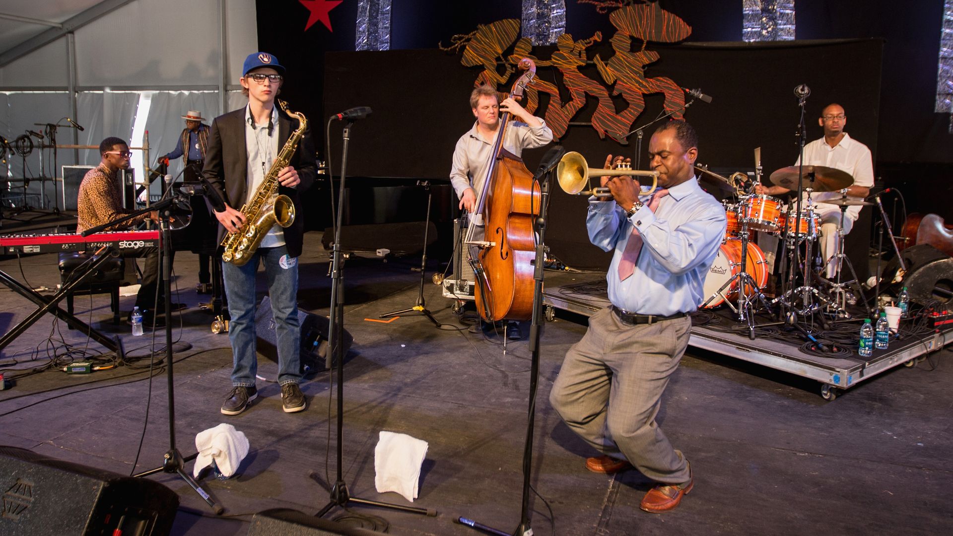 Musicians perform on a Jazz Fest stage.