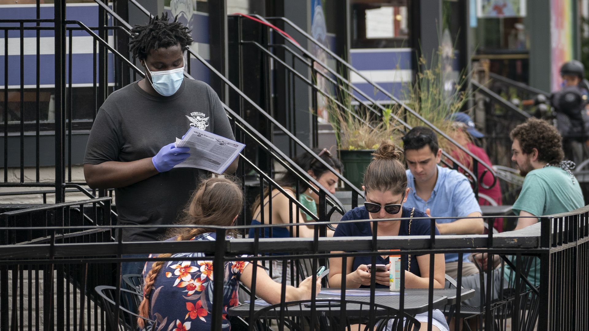 A waiter takes customers' orders in Adams Morgan.