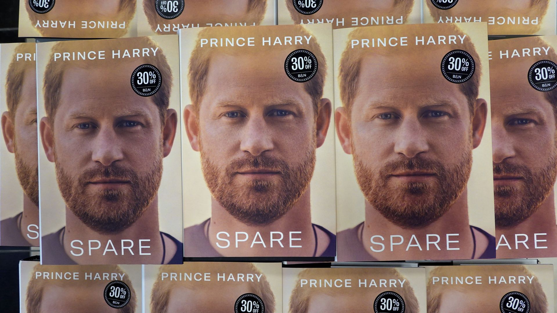 Multiple copies of Prince Harry's new book "Spare" lined up on a table.