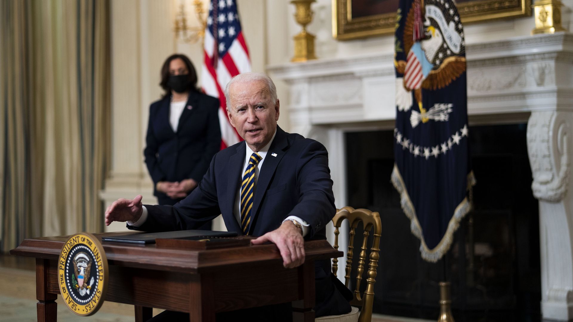 President Biden with signing executive orders with Vice President Harris in the background in the White House on Feb. 24.