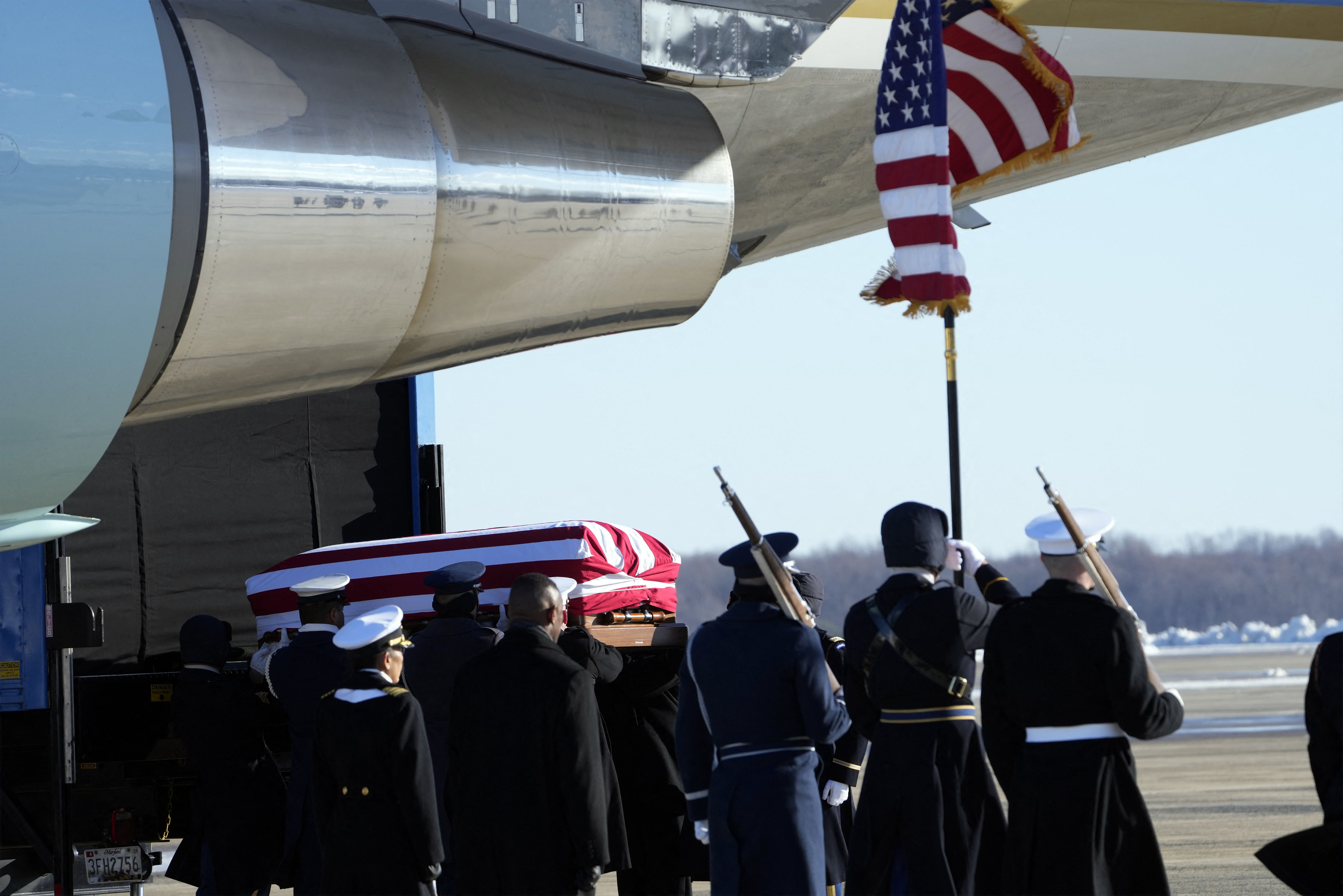 A joint forces body bearer team moves the flag-draped casket of former President Jimmy Carter upon arrival at Joint Base Andrews, Maryland on January 7, 2025. Carter, the 39th President of the United States, died at the age of 100 on December 29, 2024 at his home in Plains, Georgia. (Photo by Susan 