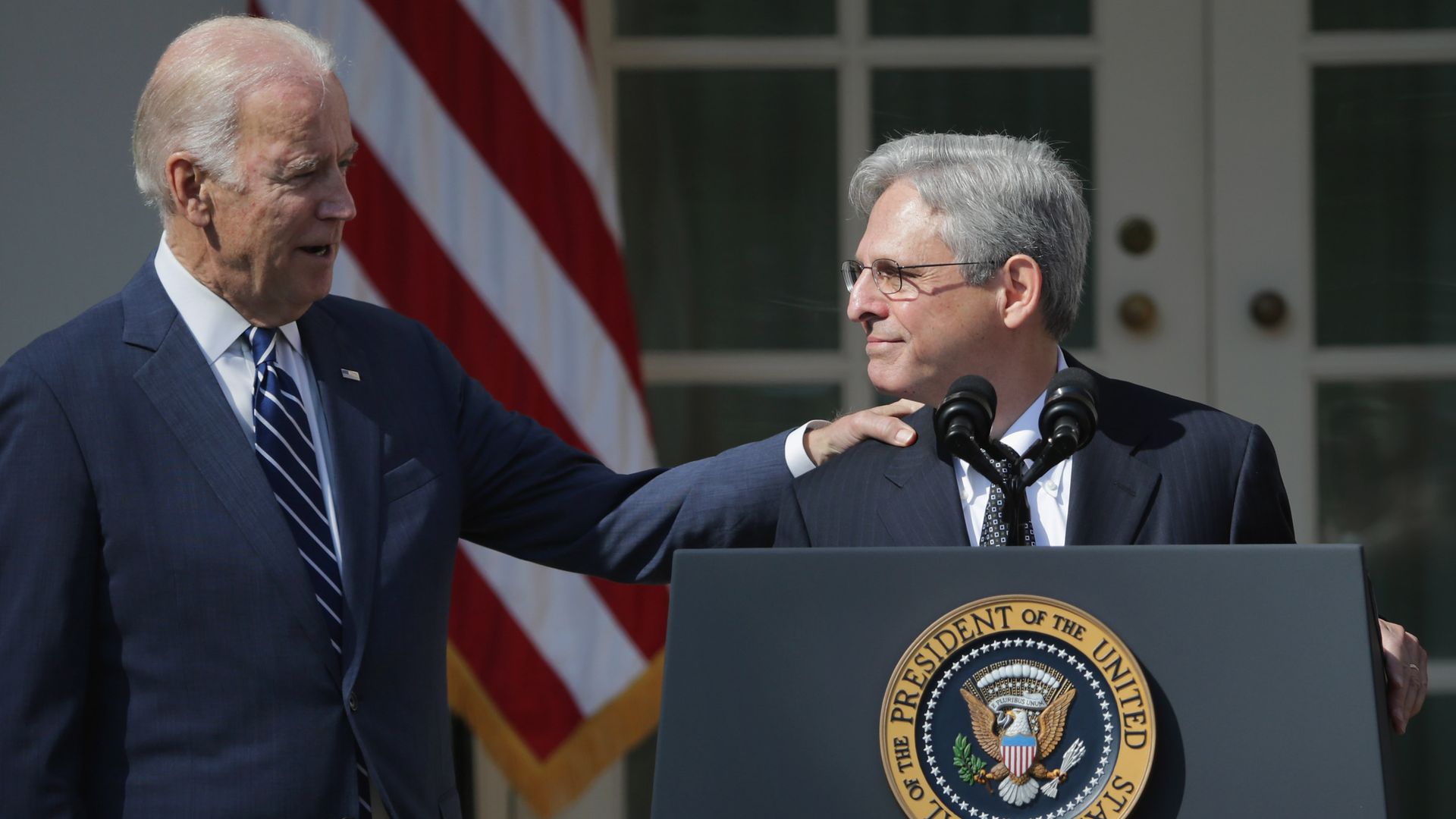 Joe Biden touches Merrick Garland on the shoulder after President Obama nominated him to the Supreme Court in 2016.