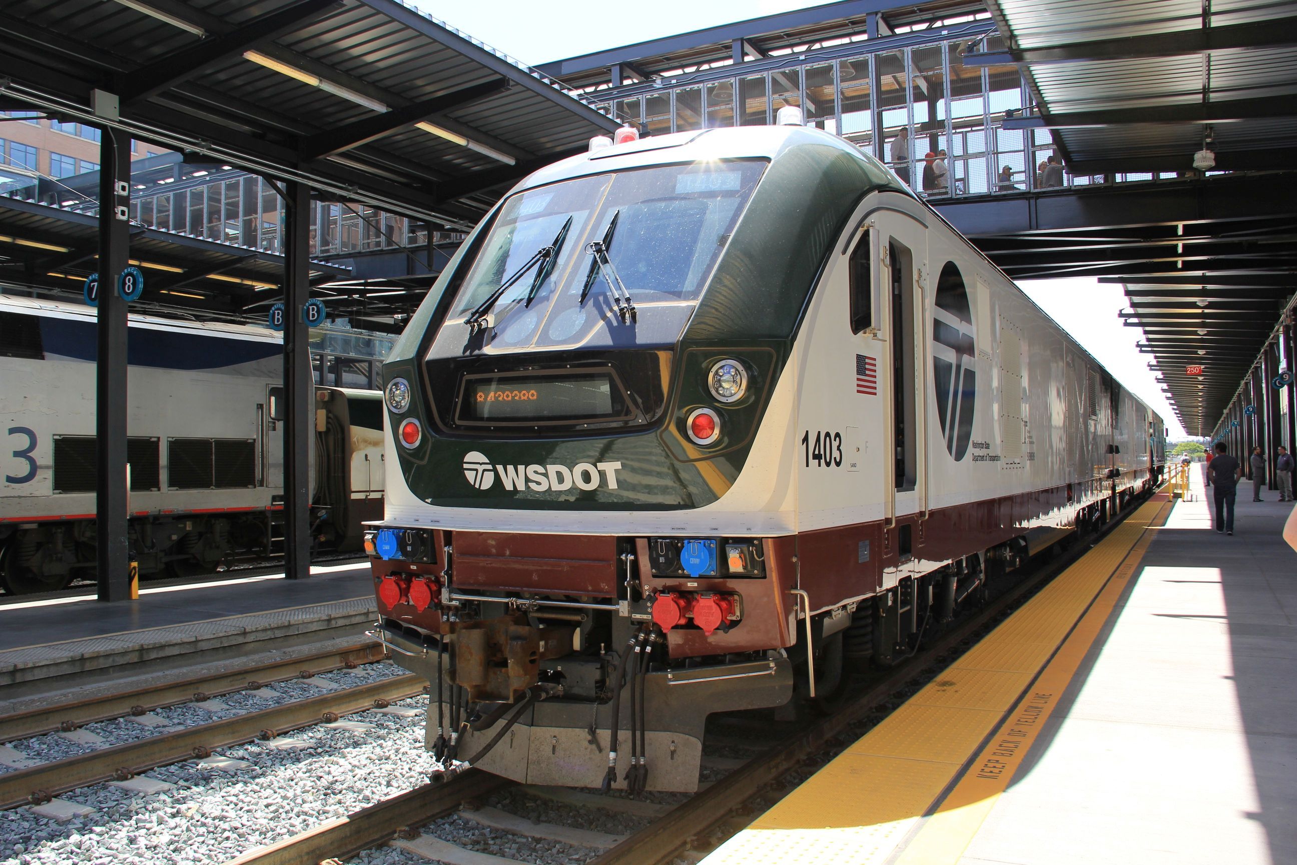 The front of a train at a platform, with the train reading "WSDOT" on the front. 