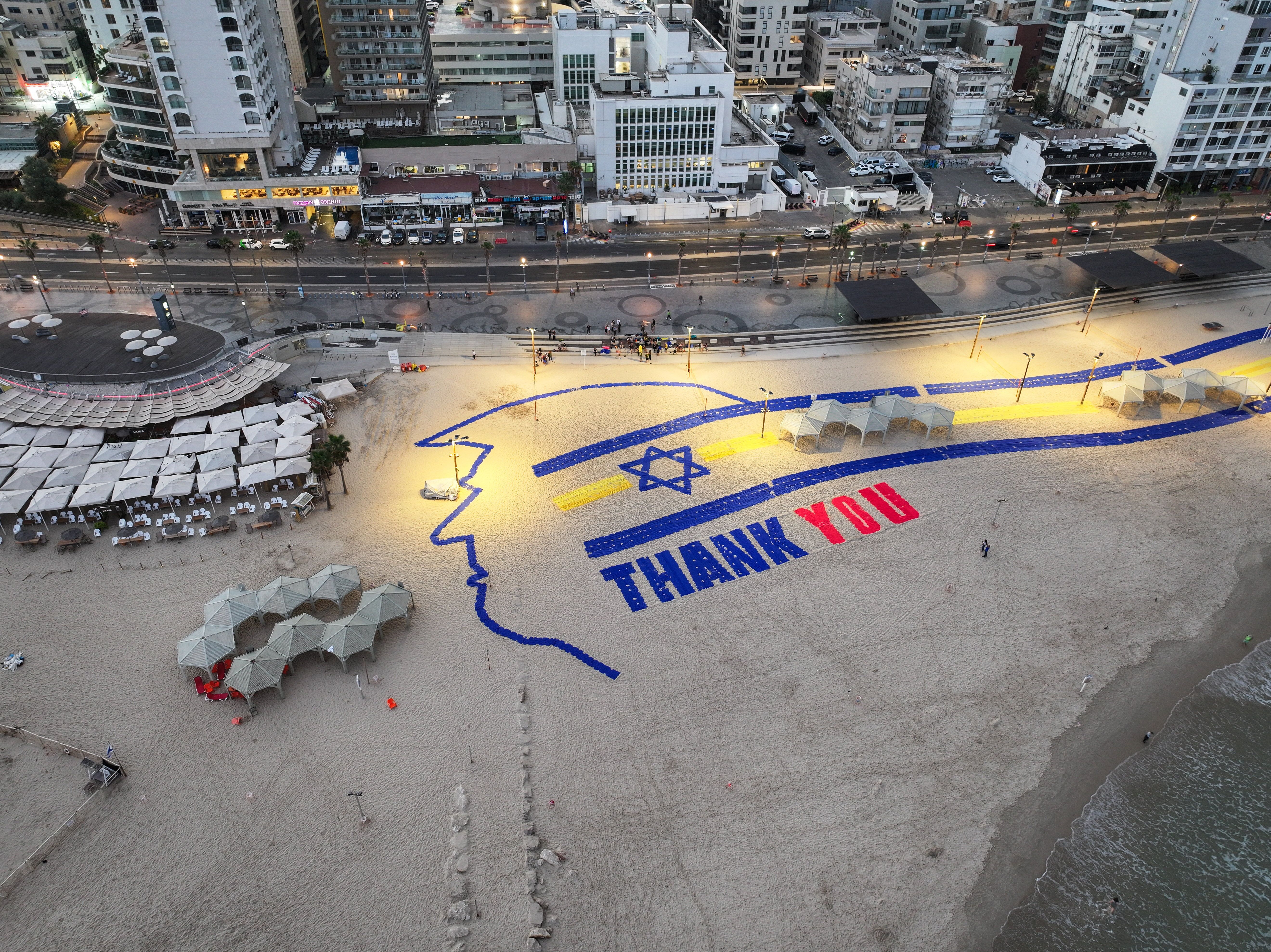 A drone view shows a depiction of U.S. President Donald Trump and the words "Thank You", on the day Israeli hostages, held in Gaza since the deadly October 7, 2023 attack by Hamas, are expected to be released as part of a U.S.-brokered hostages-prisoners swap and a ceasefire deal in Gaza between Ham