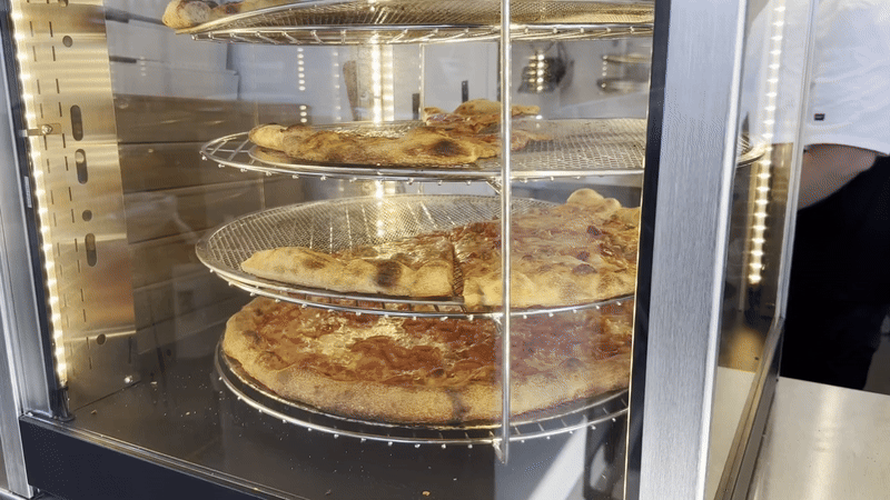 Spinning pizzas in a case 