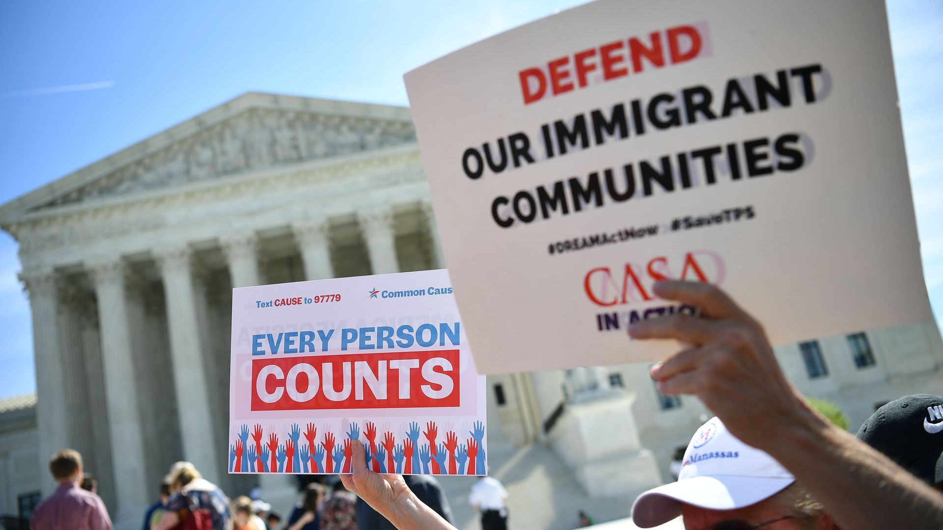 Demonstrators at the Supreme Court with signs saying "Every person counts"