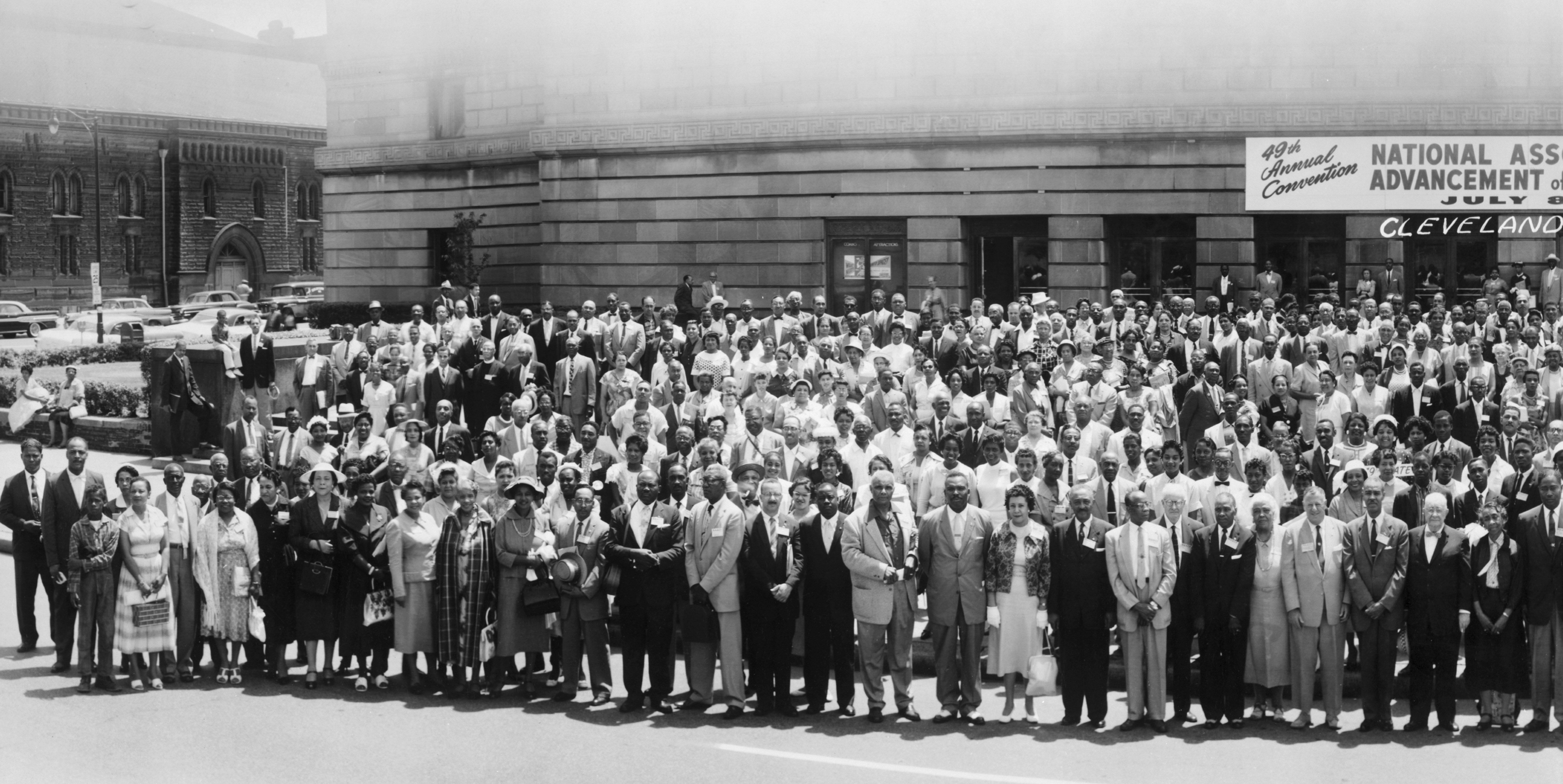 Group of people outside building in 1958