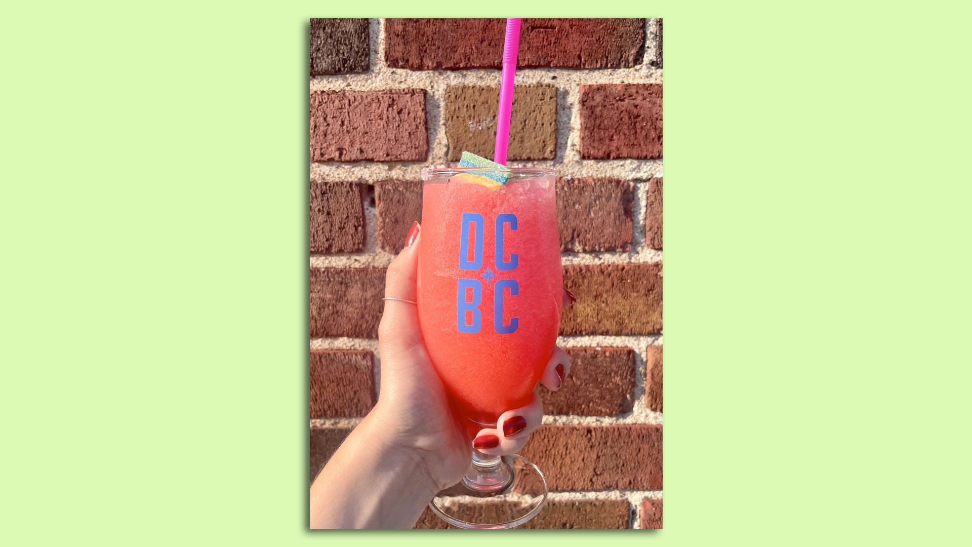 A bright pink alcoholic seltzer topped with an Airhead.