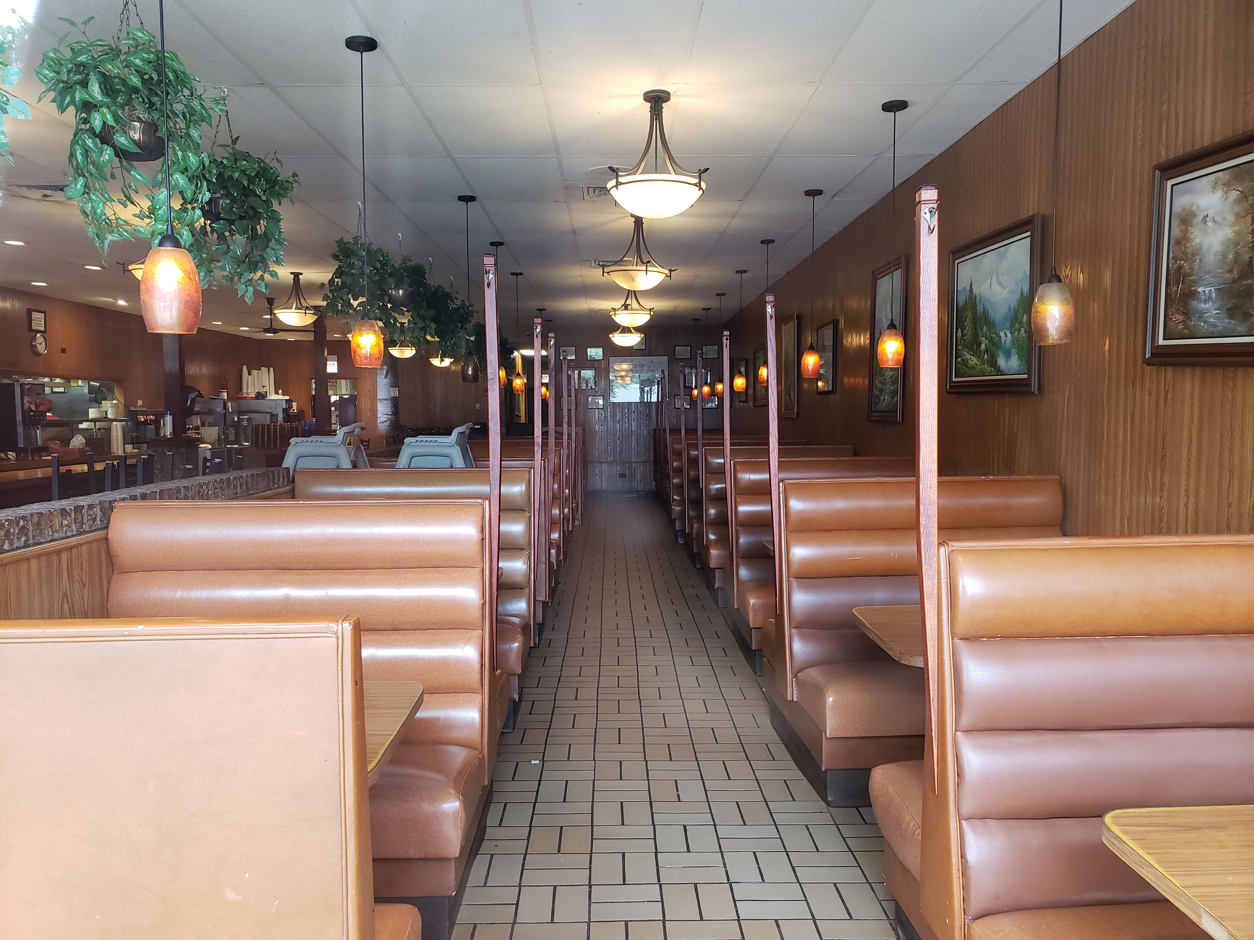 An empty diner with brown vinyl booths.