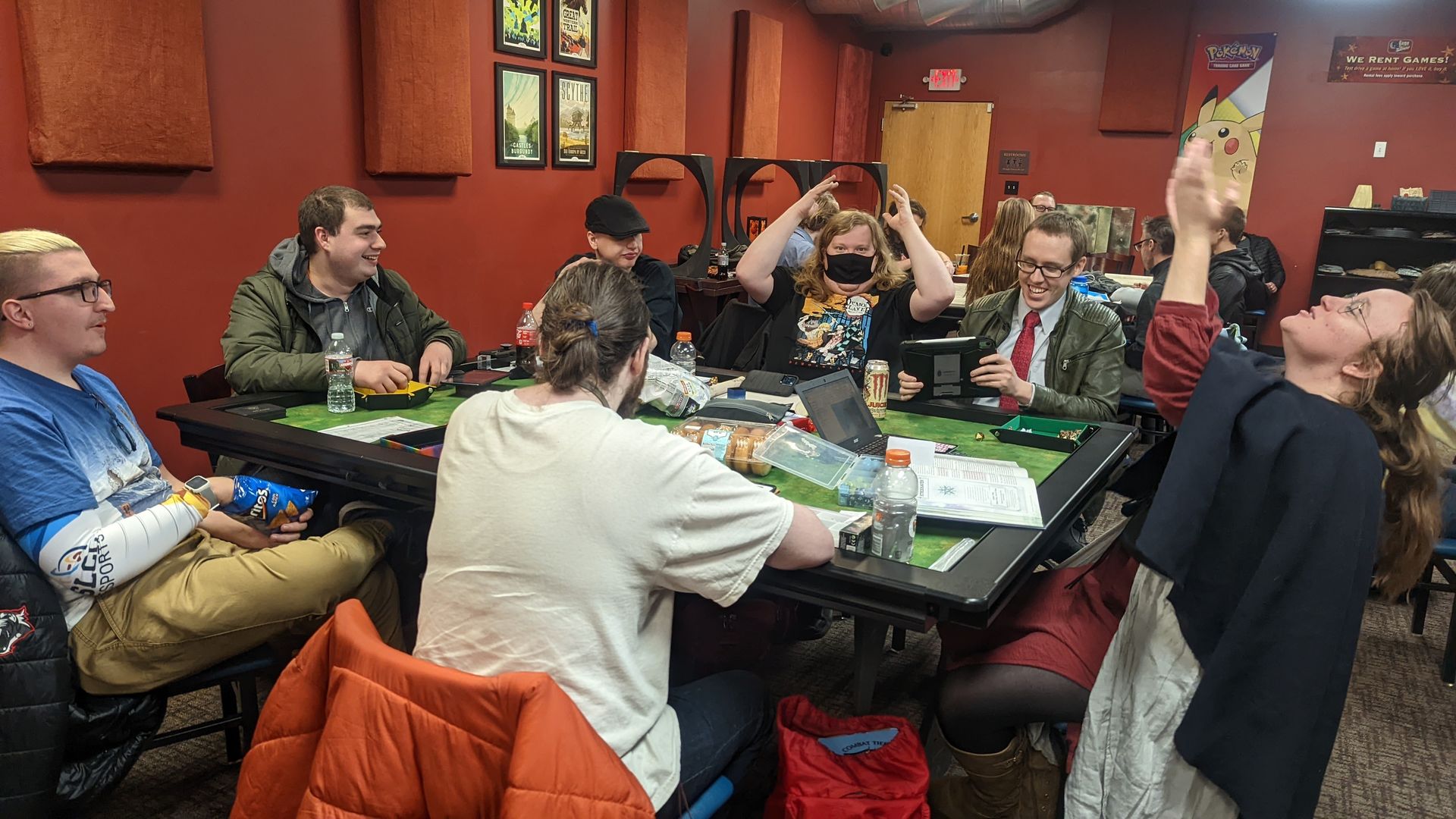 A group of people play Dungeons & Dragons around a table in a game store.