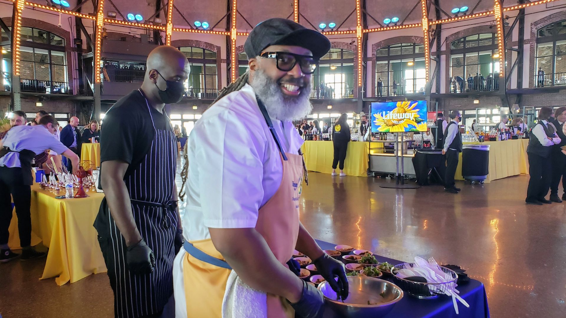 Phoot of a man making food at a table.