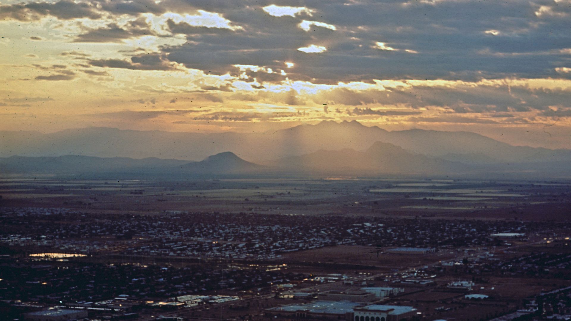 Sunrise over Superstition Mountains. Urban sprawl at the Apache Junction and Mesa area. 
