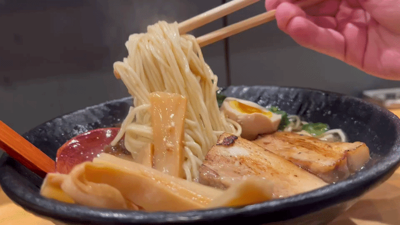 Ramen being pulled up by chopsticks