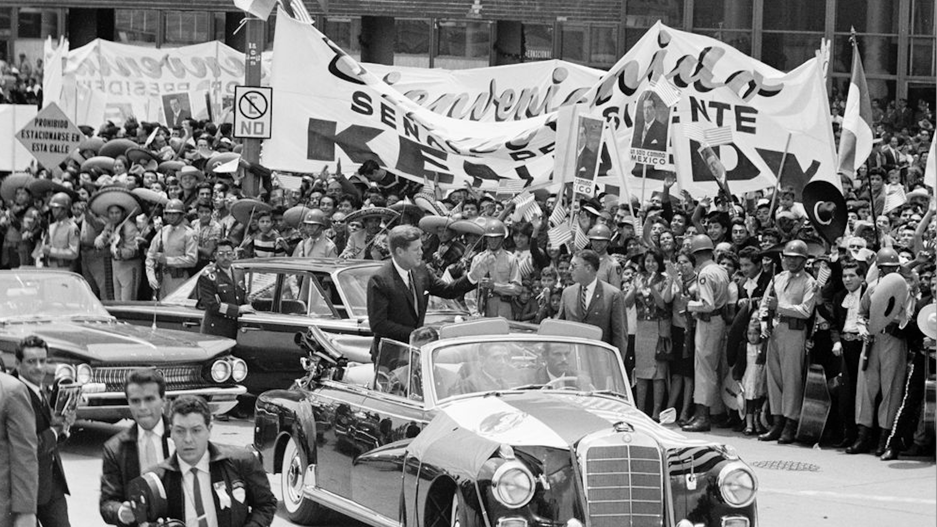 President John F. Kennedy waves from a convertible during the motorcade to Los Pinos, the official residence of the President of Mexico, following his and First Lady Jacqueline Kennedy's arrival in Mexico City, Mexico on June 29, 1962.