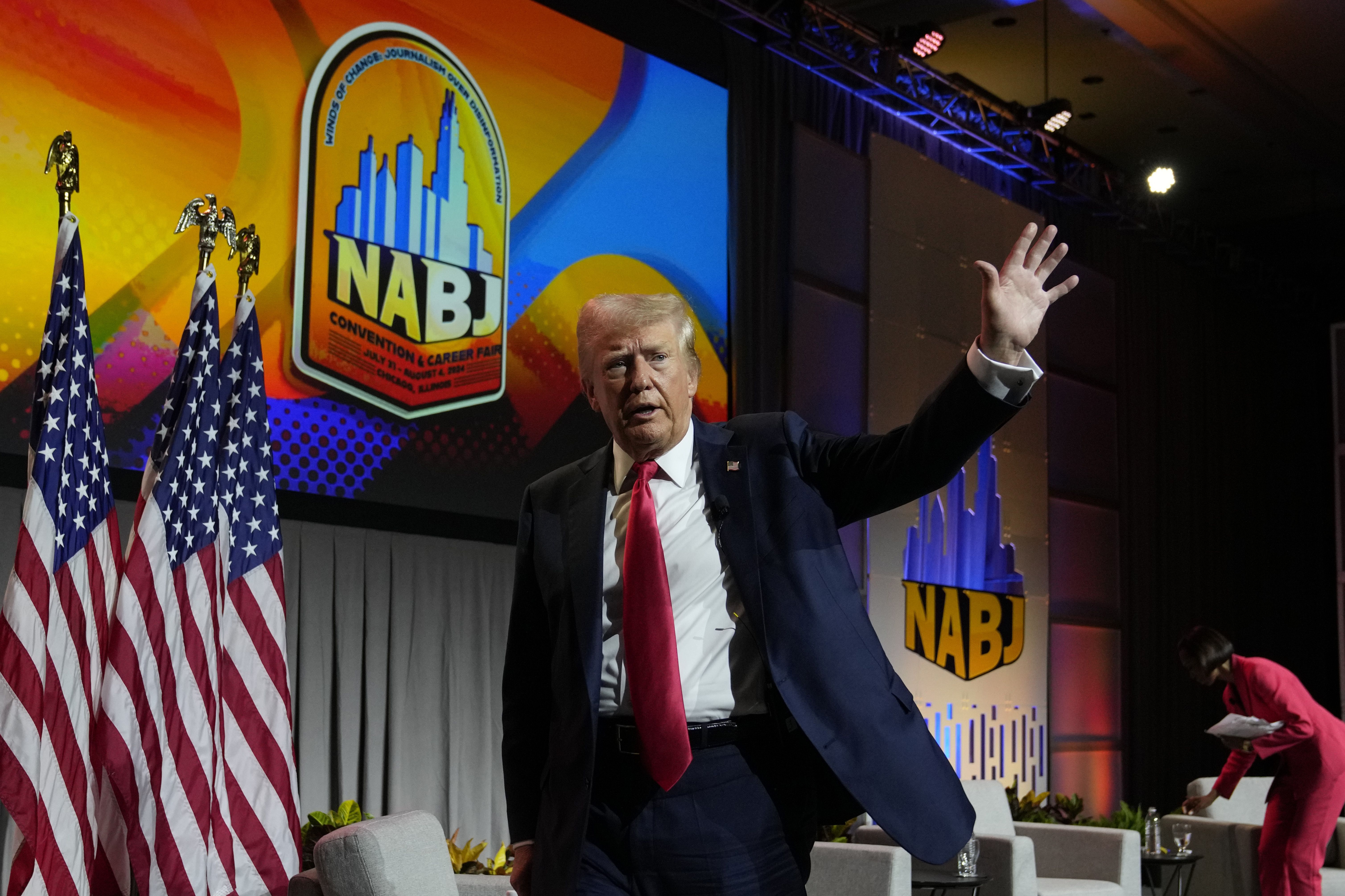 Former President Trump walks off stage after speaking at the National Association of Black Journalists in Chicago yesterday.