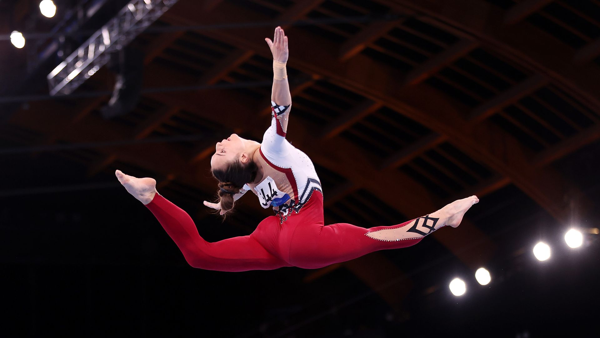 A gymnast in a full-body unitard