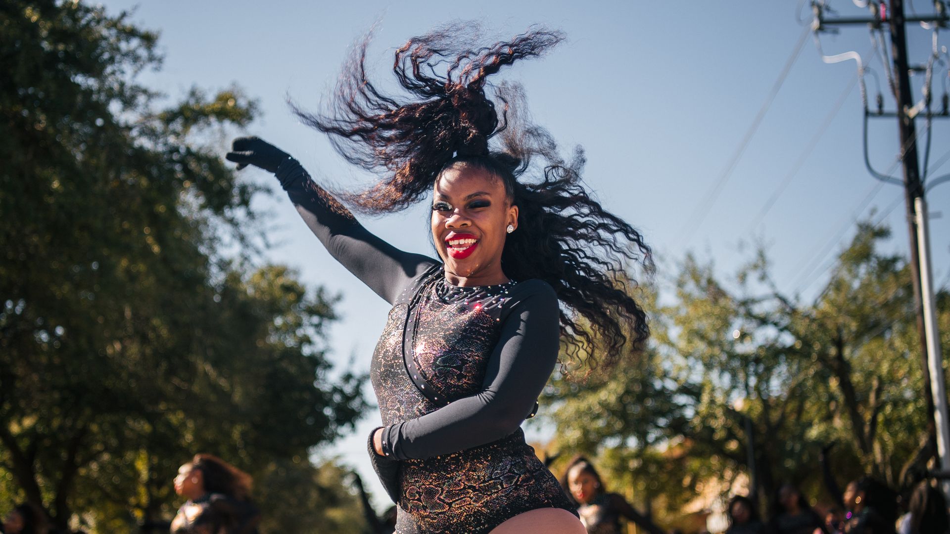 Photo of a woman wearing a leotard dancing. 