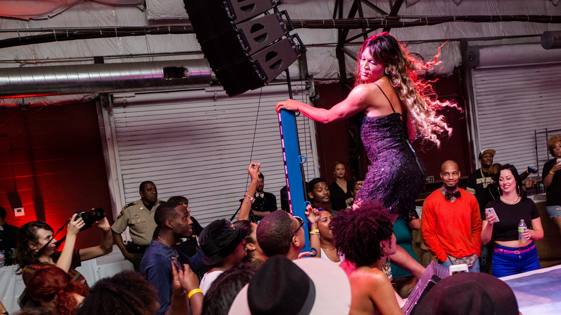 Photo shows Katey Red dancing on stage with flowing hair
